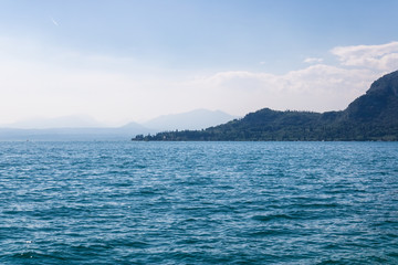 Naklejka na ściany i meble Panorama of the Garda lake surrounded by mountains, Italy - Image