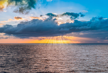 Cloudscape with sunset and sunbeam over the sea, Guadeloupe, Caribbean.