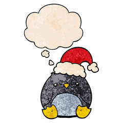 cute cartoon penguin wearing christmas hat and thought bubble in grunge texture pattern style