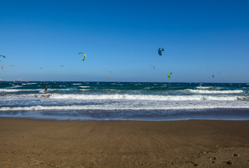 Aerial view of Kitesurfing on the waves of the sea. Kitesurfing, El Medano, Tenerife, Spain.
