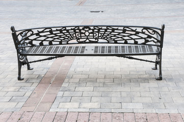 Empty cast iron bench in park