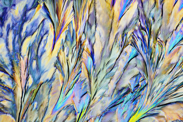 Colorful micro crystals in polarized light. Photo through a microscope.