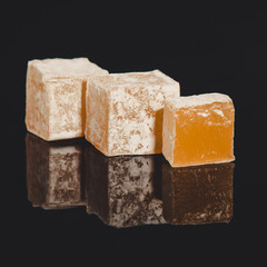 Turkish delight, sweets on a black background (dessert sweets) lokum. food background. top view. copy space