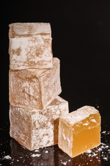 Turkish delight, sweets on a black background (dessert sweets) lokum. food background. top view. copy space