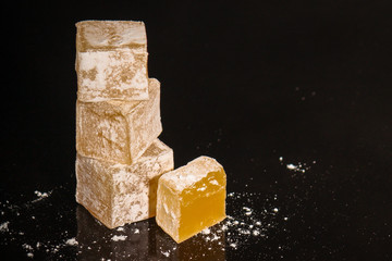 Turkish delight, sweets on a black background (dessert sweets) lokum. food background. top view. copy space