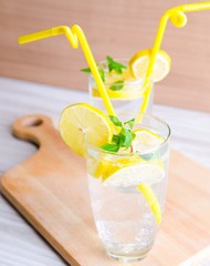 Glasss of mojito with lemon and drinking straw