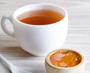 Cup of tea served with orange jam