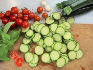 courgettes sliced on a wooden board