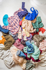 pile of used clothes on a light background. Second hand for recycling