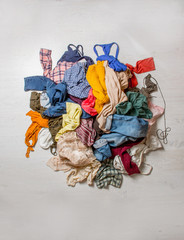 pile of used clothes on a light background. Second hand for recycling - 275994280