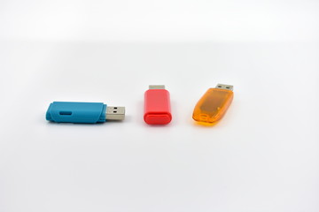 USB flash memory drives with colours on a white background.