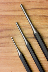 Punch tool on wooden background