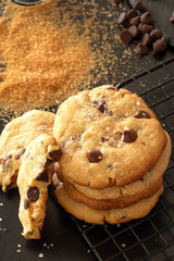 Homemade salted caramel chocolate chips cookies. Dark background.