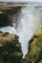 Waters of the Gullfoss waterfall falling into the river between the rocks. Landscapes of Iceland