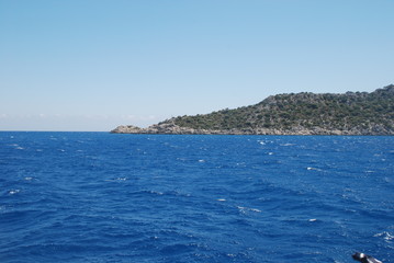 Beautiful view of the Mediterranean Sea and rocky shore under the blue sky