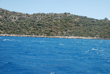 Naklejka premium Beautiful view of the Mediterranean Sea and rocky shore under the blue sky