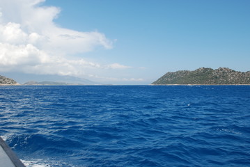 Naklejka na ściany i meble Beautiful view of the Mediterranean Sea and rocky shore under the blue sky