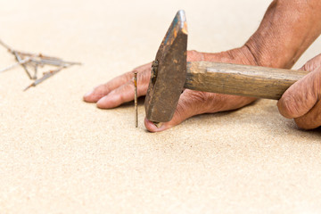 The man hit his finger with a hammer. Professional carpentry, woodwork and people. concept of...