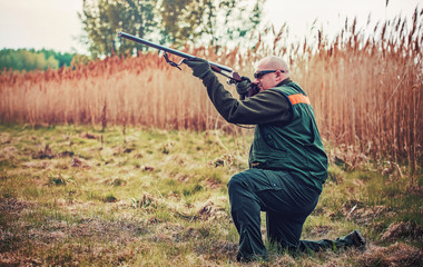 Fototapeta premium Hunter with a rifle in hunting
