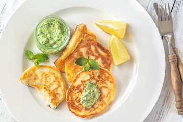 Portion of ricotta fritters with mint sauce