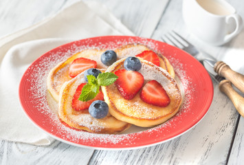 Portion of ricotta fritters with fresh berries