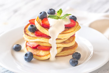 Portion of ricotta fritters with fresh berries