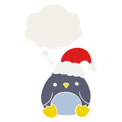 cute cartoon penguin wearing christmas hat and thought bubble in retro style