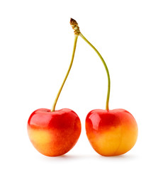 Two yellow cherries with a red side on a white, isolated.