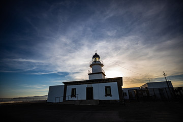 Beautiful sunset behind a white lighthouse