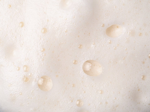 Foam Texture Extreme Close Up As Background. Beer Or Cappucino Foam With Bubbles Macro Shoot. Copy Space For Text.