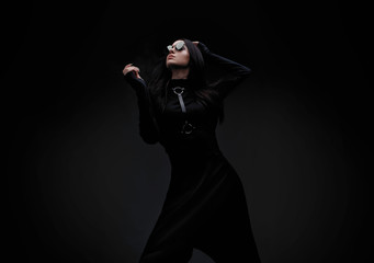 Portrait of mysterious sensual beautiful brunette woman in black futuristic dress. High fashion...