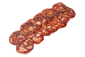 Spanish pork chorizo sausage slices, close-up, isolated on white background