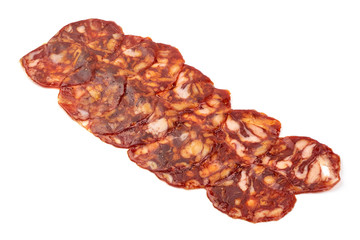 Spanish pork chorizo sausage slices, close-up, isolated on white background