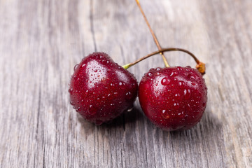 Fresh ripe black cherries on a gray wooden background Close up - Image