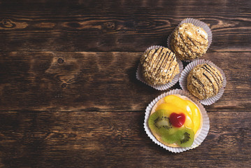 Cakes on a plate on a wooden table background...