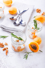 Natural yogurt with pieces of apricots and rosemary