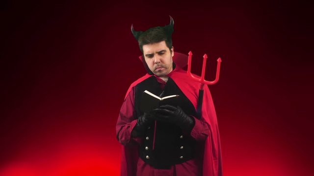 Devil man looking at notebook