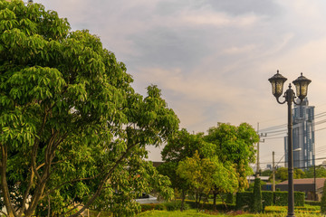 Two lamps in vintage style in front of a big,modern building