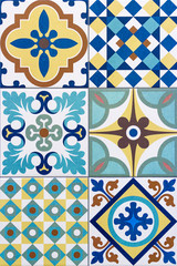 Detail of traditional portuguese tiles with colorful ornaments. Vertical background. Detail of traditional tiles from the facade of an old house in Porto, Portugal. Traditional Portugal pottery.