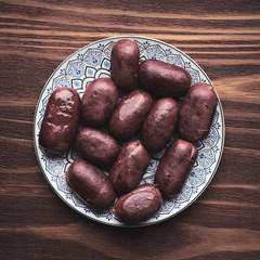 raw black pudding on wooden board