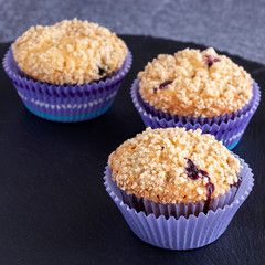 Blueberries Apple Oats streusel Muffins on slate board. Selective focus. Copy space for text. Healthy breakfast concept.