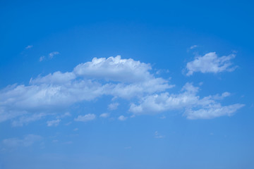 Obraz premium light fluffy clouds on a bright blue sky