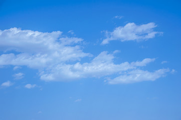 light fluffy clouds on a bright blue sky