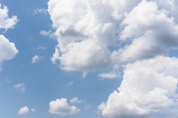 Naklejka na ściany i meble Blue sky background with a fluffy clouds