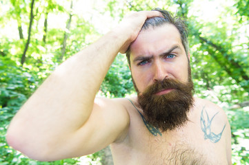 Sweating and body odor care. Perspiring hipster touching his wet hair. Bearded man experiencing...