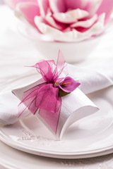 Beautiful table setting with small present for the guest