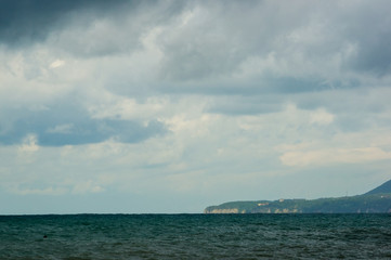 sea landscape is a pebbly beach with waves in white foam