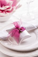 Beautiful table setting with small present for the guest