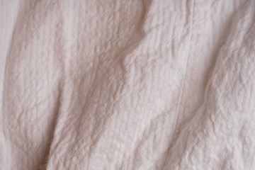 Fototapeta na wymiar Crumpled white fabric with a large texture.