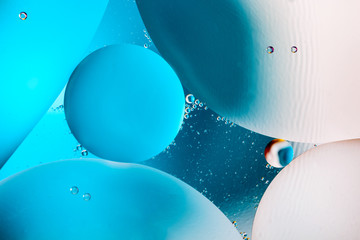 Beautiful color abstract background from mixied water and oil. Pastel colored abstraction. Blue and...